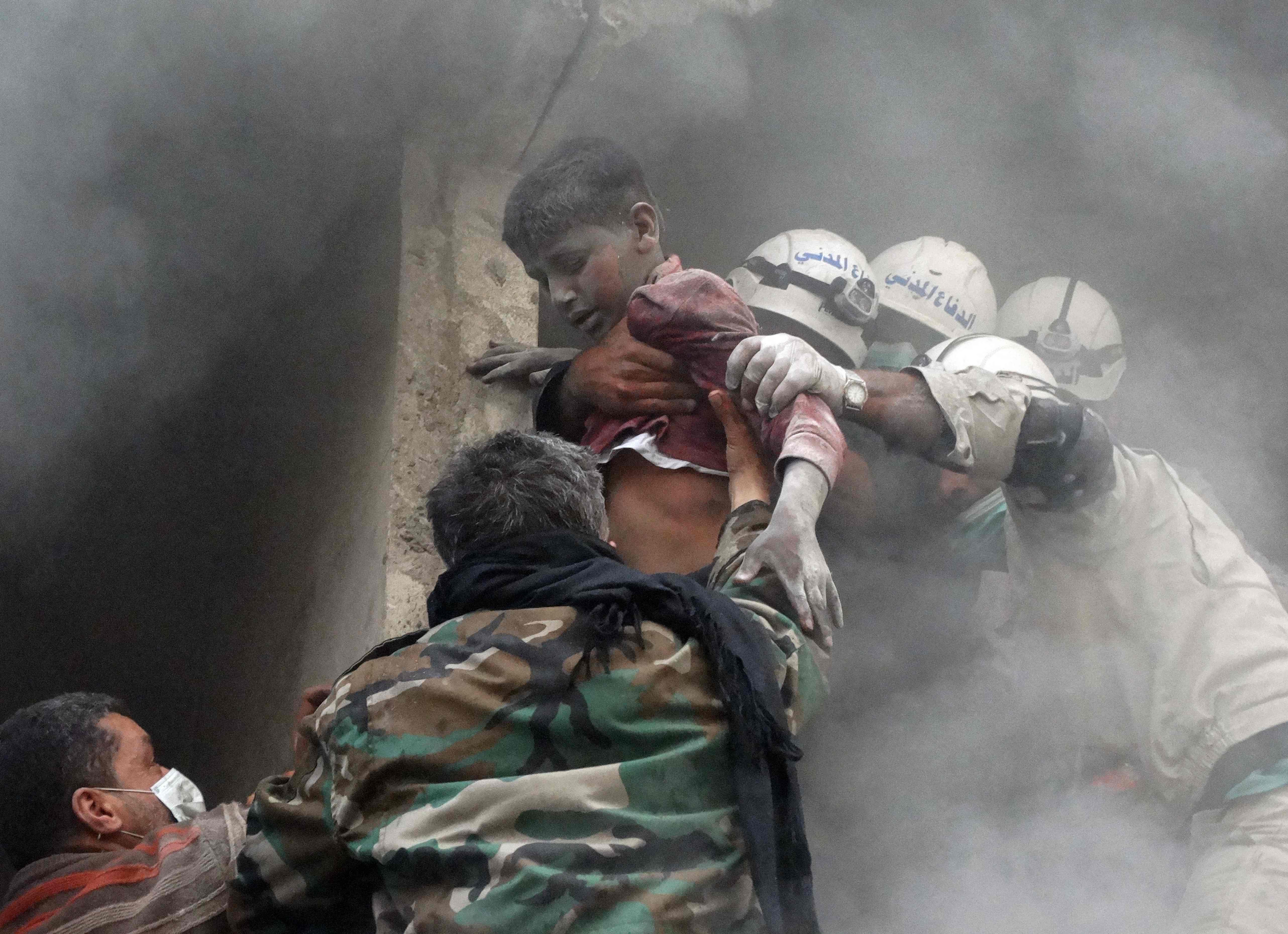 A Syrian boy recued from a building in Aleppo following an airstrike