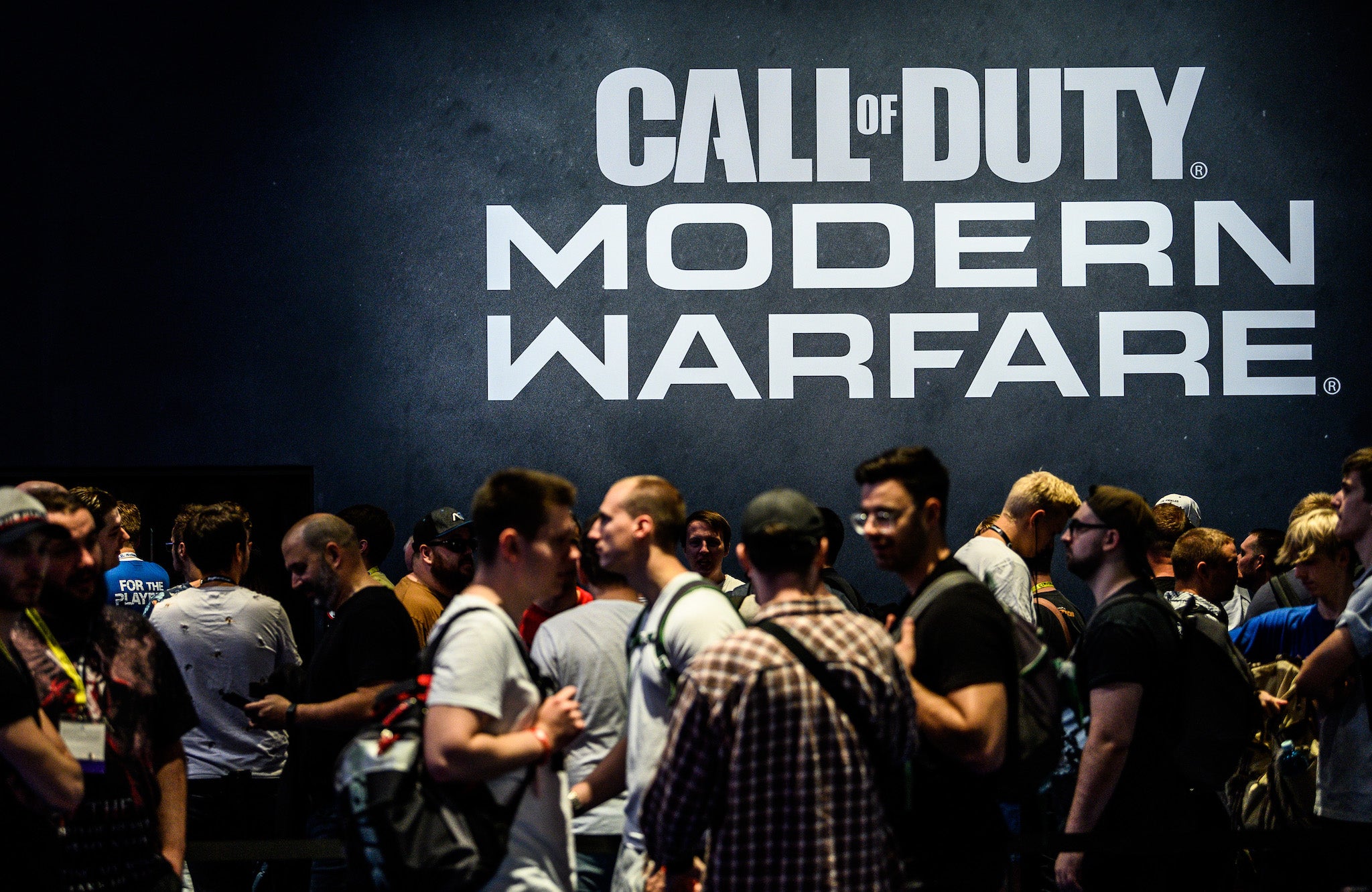 Visitors wait to try out the latest version of Call of Duty Modern Warfare during the press day at the 2019 Gamescom gaming trade fair on August 20, 2019 in Cologne, Germany