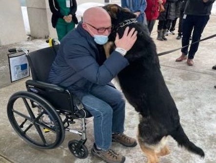 <p>Brian Myers with Sadie outside of the Englewood Health hospital in February 2021</p>