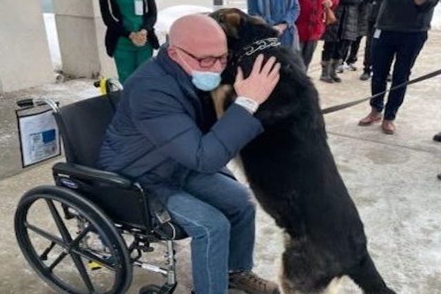 <p>Brian Myers with Sadie outside of the Englewood Health hospital in February 2021</p>