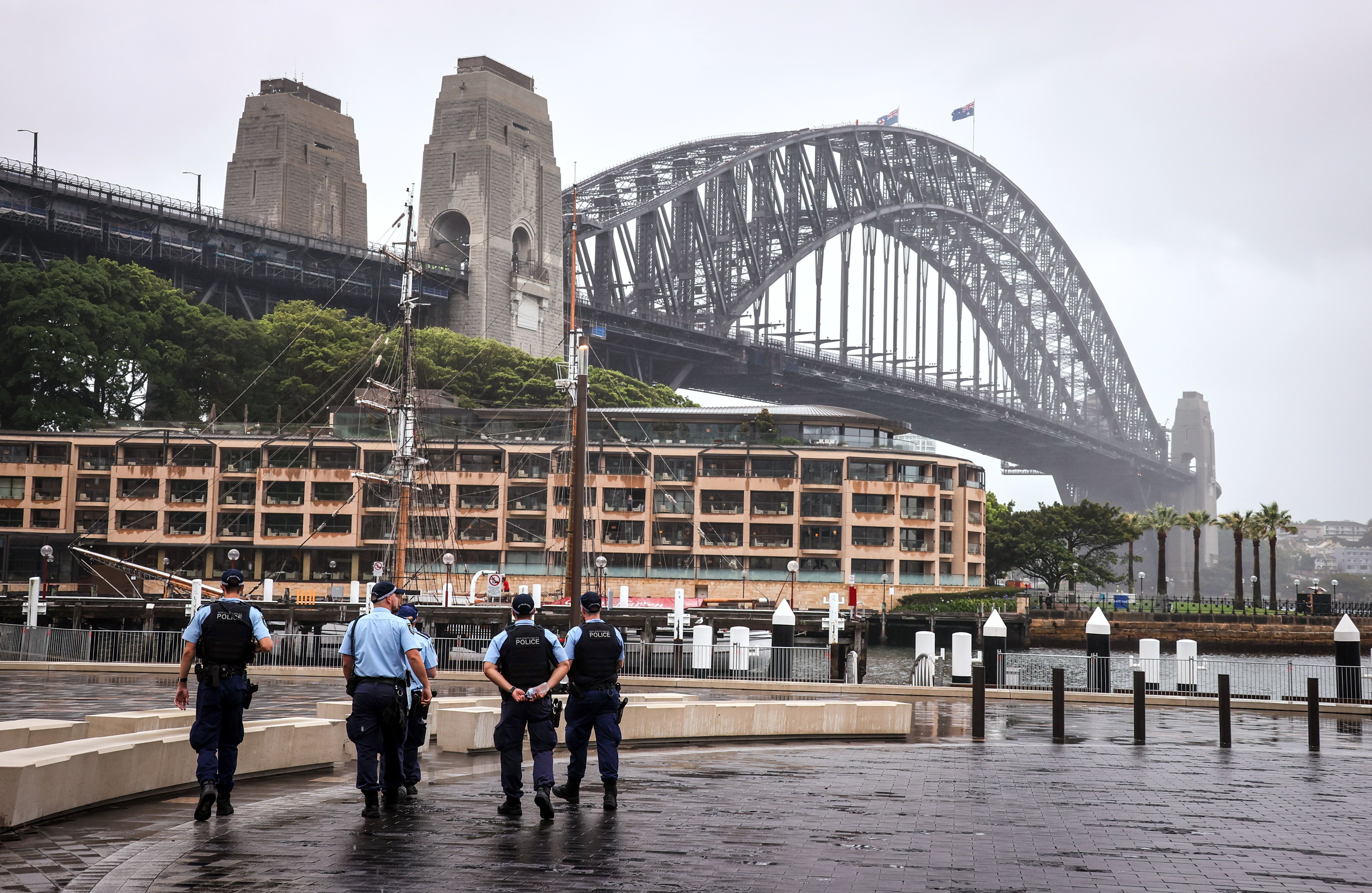 New South Wales police officers patrol an area in front of the Harbour Bridge in central Sydney on 31 December, 2020. Police are investigating after a group of Sikh men were attacked in a vehicle.