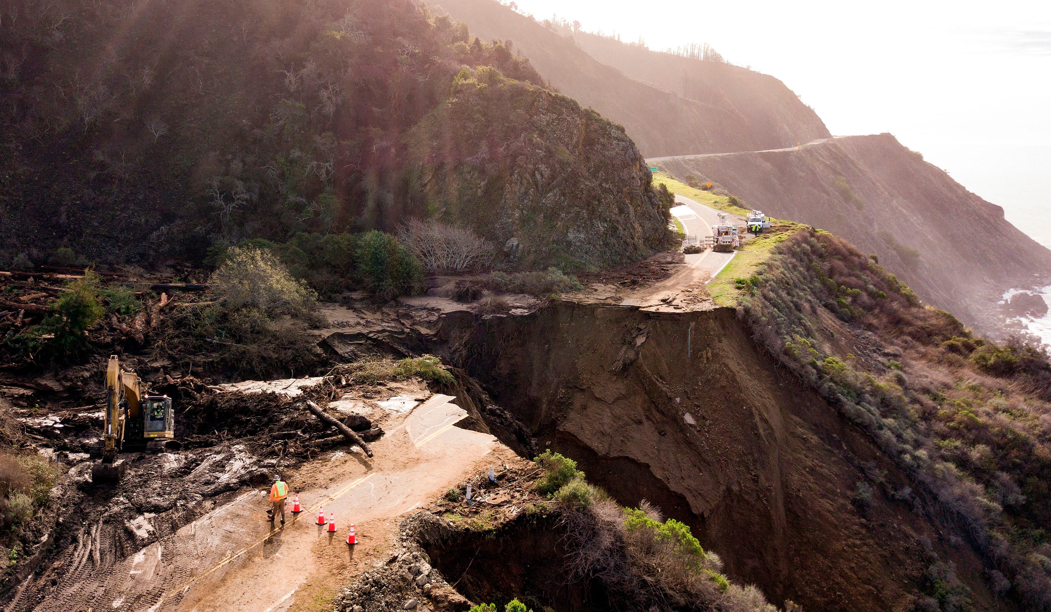 Construction crews work on a section of Highway 1, which collapsed into the Pacific Ocean near Big Sur, California on January 31, 2021. Heavy rains caused debris flows of trees, boulders and mud that washed out a 150-foot section of the road.