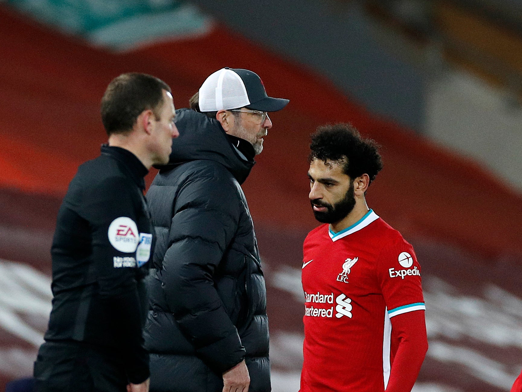 Mohamed Salah walks past Jurgen Klopp after being substituted