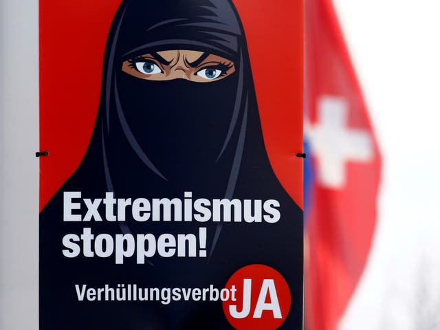 A poster featuring a frowning woman wearing a black face covering and the words: ‘Stop extremism! Veil ban - Yes'