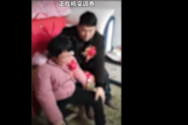 <p>A Chinese man, 55, can be seen consoling a 20-year-old mentally unstable woman after reportedly marrying her </p>