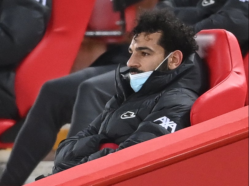 Salah sits in the stands after being substituted against Chelsea