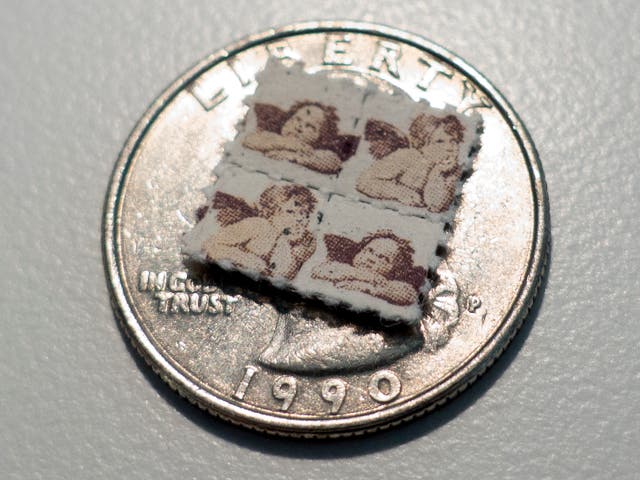 This photo shows LSD blotter tabs on top of a US quarter coin on April 12, 2017, in Washington, DC.  
