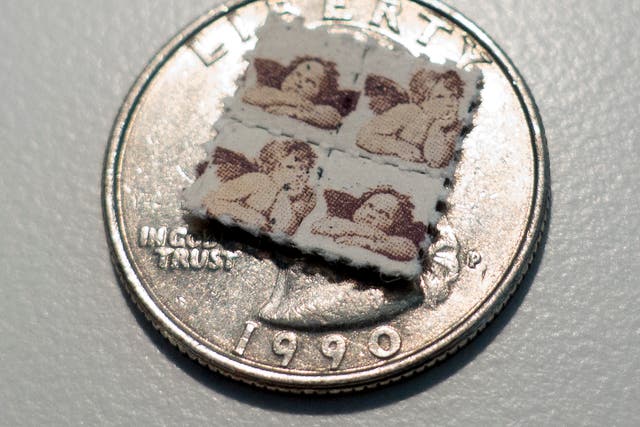This photo shows LSD blotter tabs on top of a US quarter coin on April 12, 2017, in Washington, DC.  