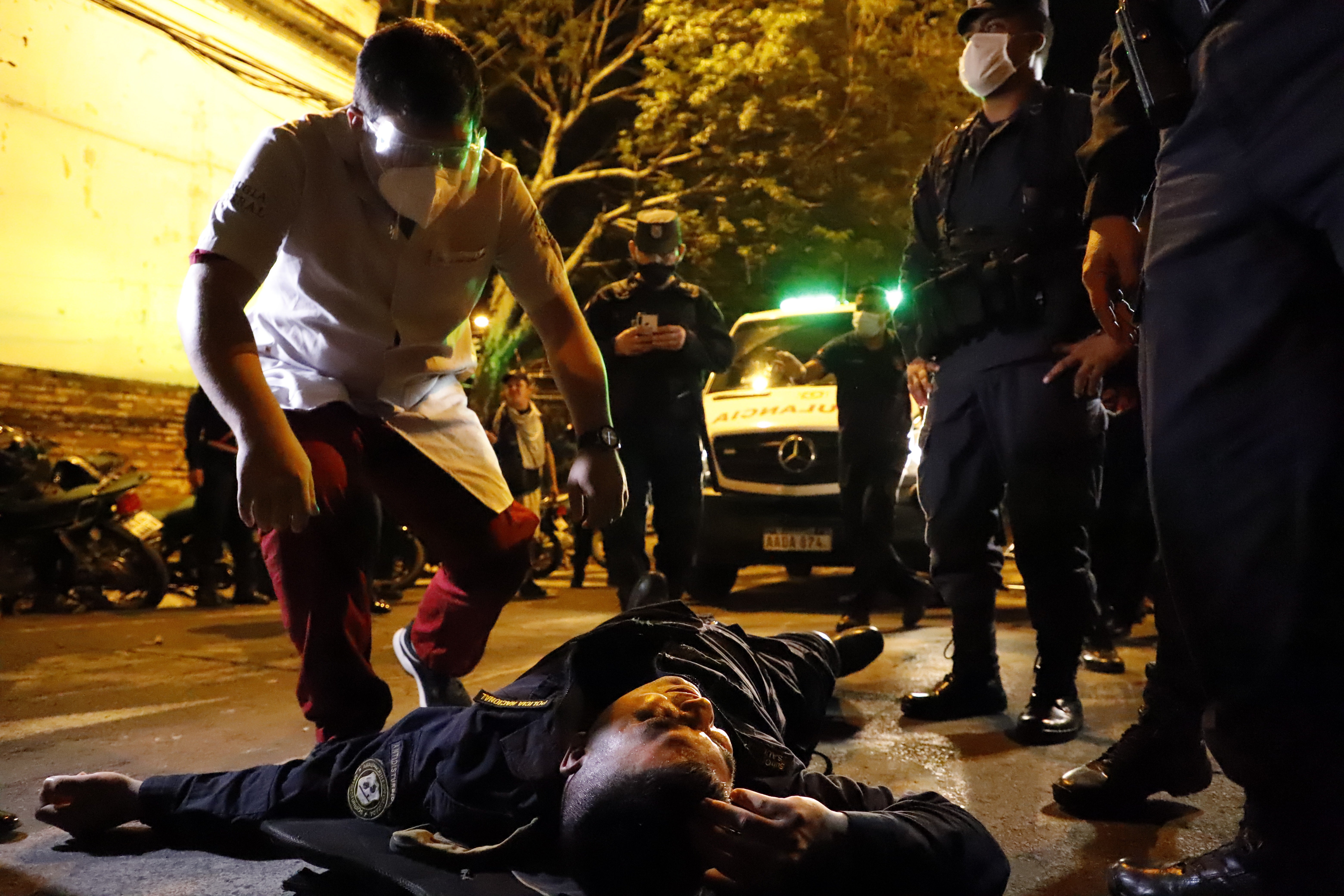 A policeman lies injured in the streets