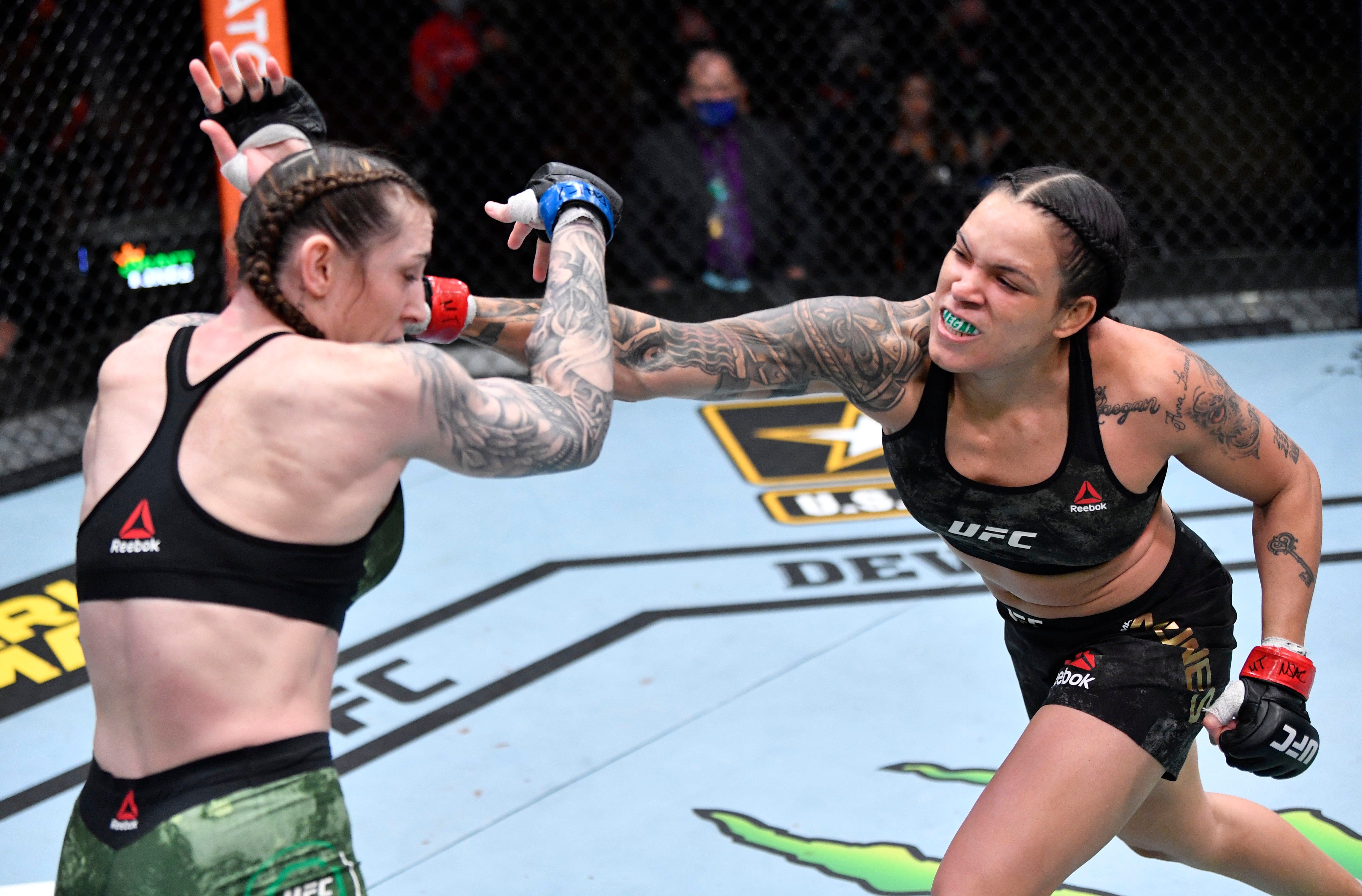 Amanda Nunes (right) retained her women’s featherweight title in dominant fashion