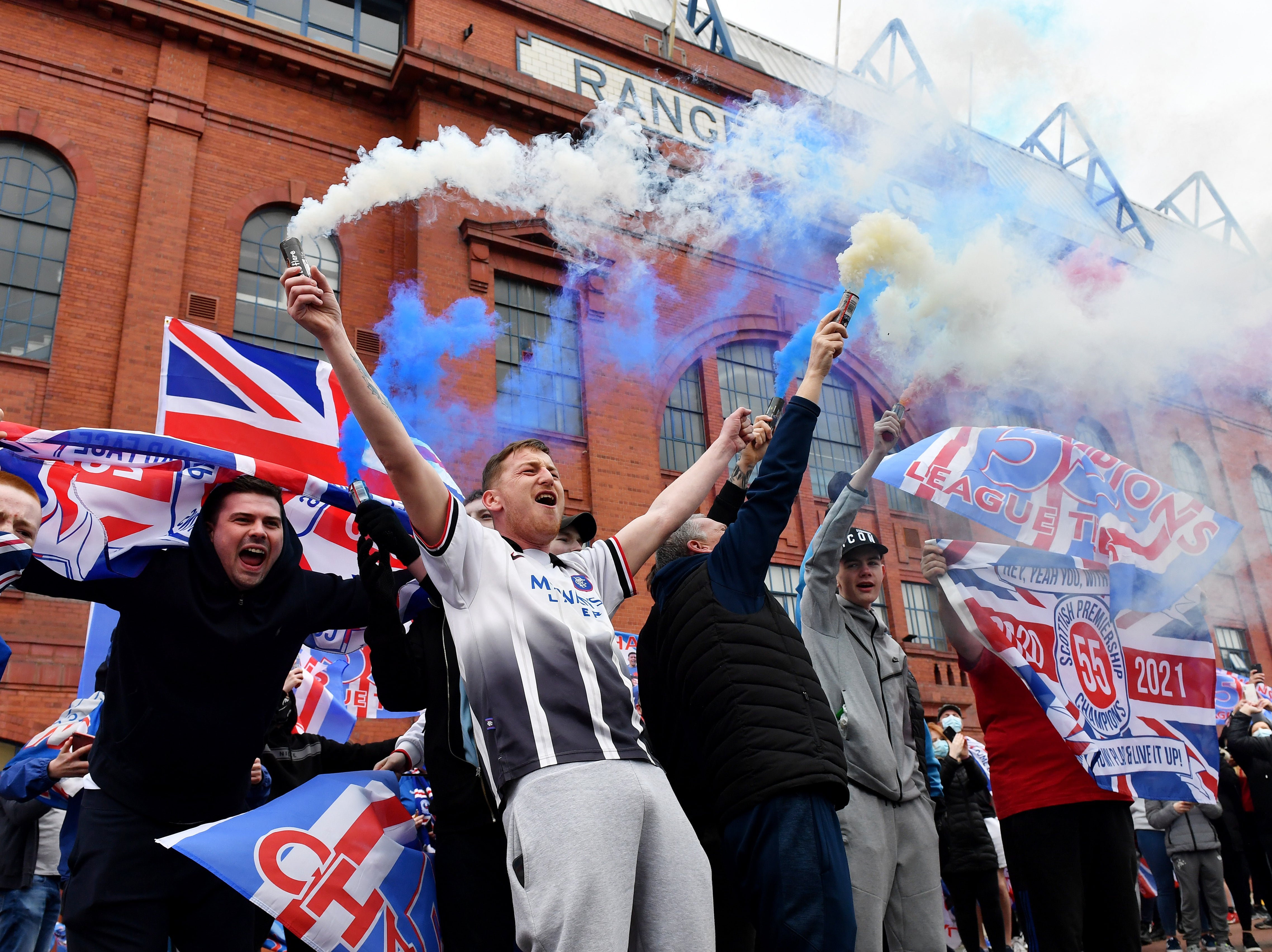 Rangers fans celebrate outside the club’s Ibrox Stadium