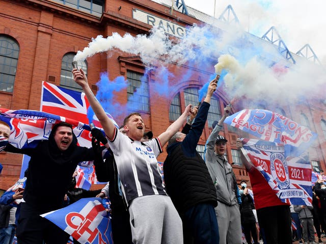 Rangers fans celebrate outside the club’s Ibrox Stadium