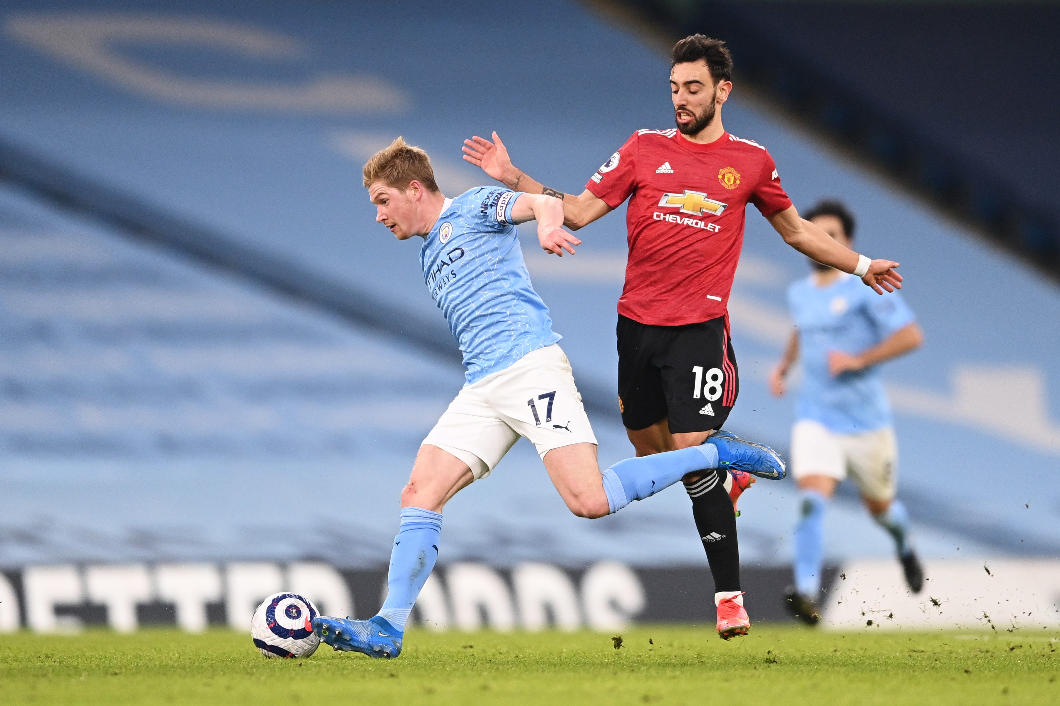 Kevin De Bruyne (left) vies with Fernandes for the ball