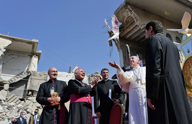 <p>Pope Francis, accompanied by the Chaldean Catholic Archbishop of Mosul Najib Michaeel Moussa (left), looks on at a square near the ruins of the Syriac Catholic Church of the Immaculate Conception (al-Tahira-l-Kubra), in Mosul on 7 March, 2021</p>