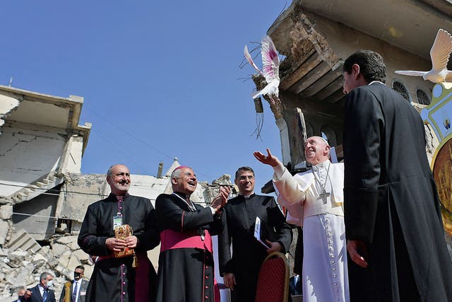 <p>Pope Francis, accompanied by the Chaldean Catholic Archbishop of Mosul Najib Michaeel Moussa (left), looks on at a square near the ruins of the Syriac Catholic Church of the Immaculate Conception (al-Tahira-l-Kubra), in Mosul on 7 March, 2021</p>