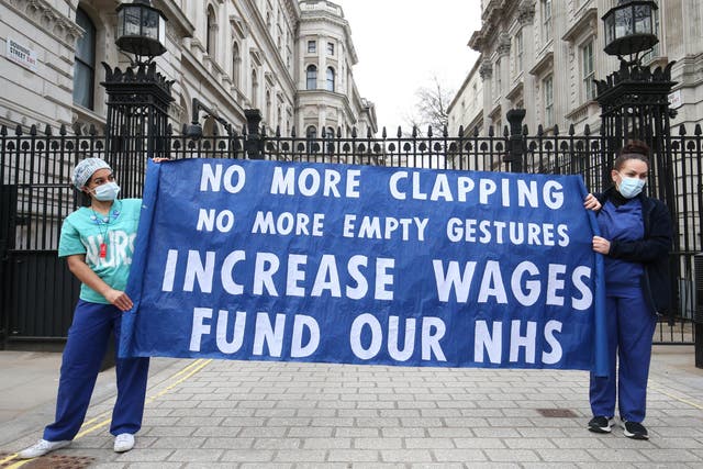 <p>Nurses and NHS workers hold a socially distanced protest outside Downing Street in London</p>