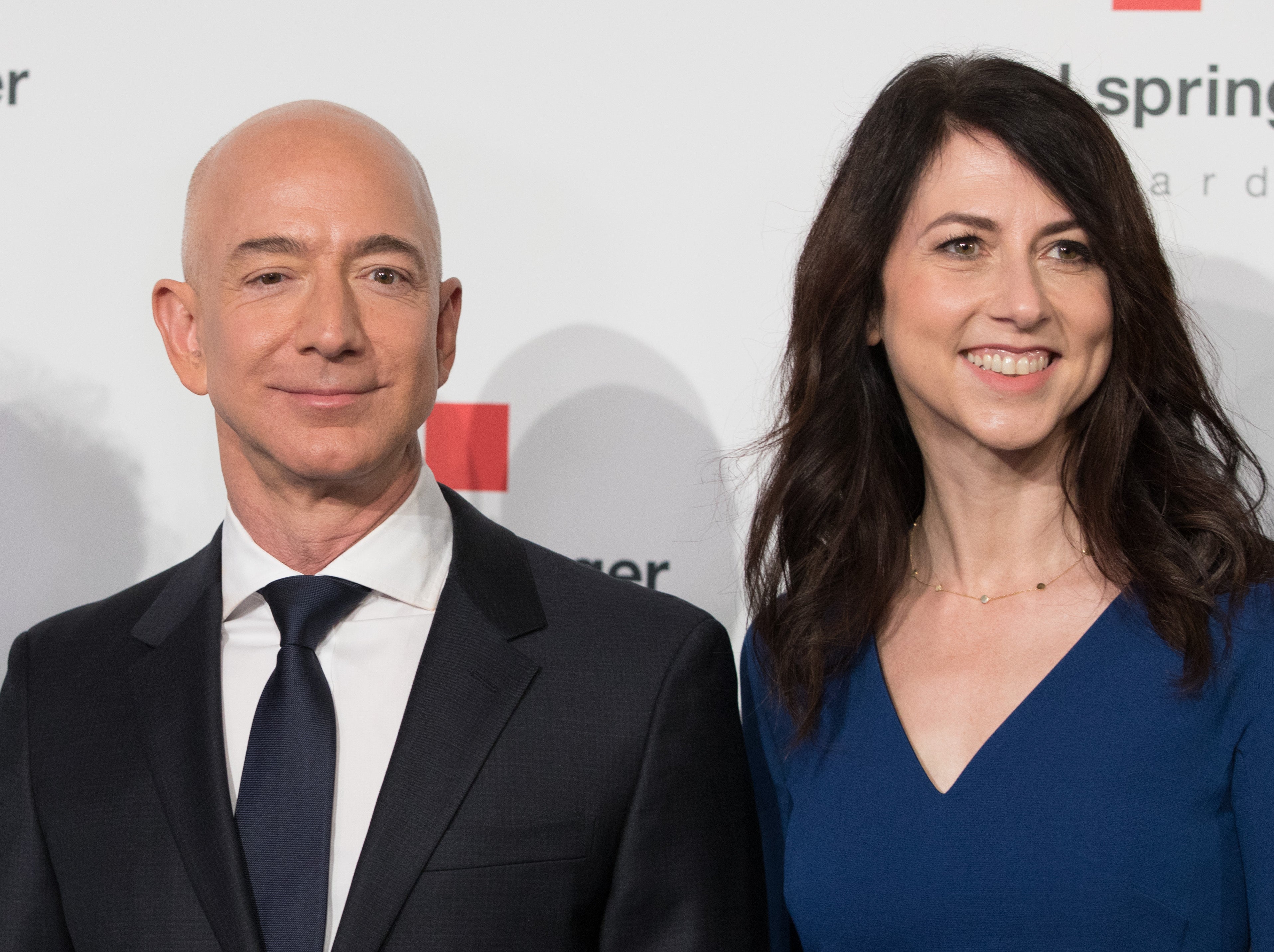 Amazon CEO Jeff Bezos and his wife MacKenzie Bezos poses as they arrive at the headquarters of publisher Axel-Springer where he will receive the Axel Springer Award 2018 on April 24, 2018 in Berlin.