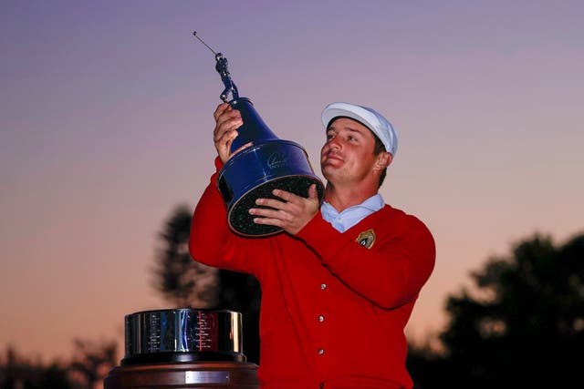 <p>Bryson DeChambeau celebrates with the trophy after winning the 2021 Arnold Palmer Invitational</p>