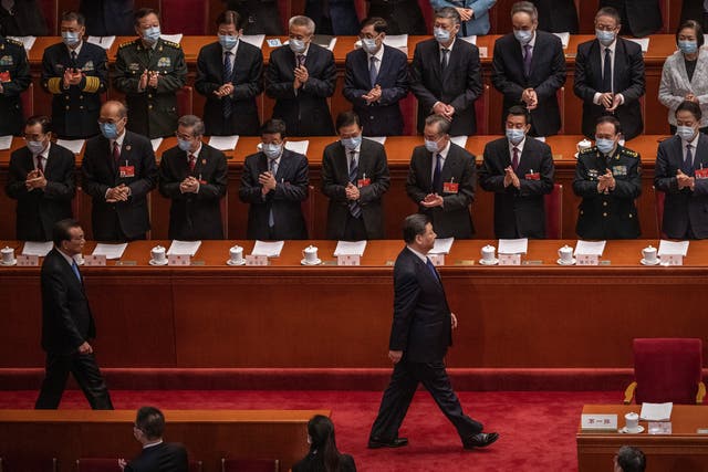<p>Chinese president Xi Jinping and premier Li Keqiang are applauded as they arrive at the second plenary session of the National People's Congress in Beijing, China</p>