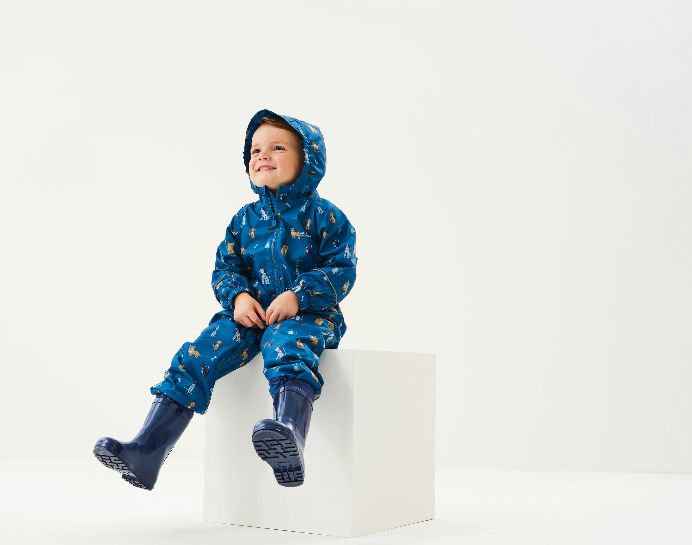 child wearing Regatta Peppa Pig Blue Waterproof Pobble Suit