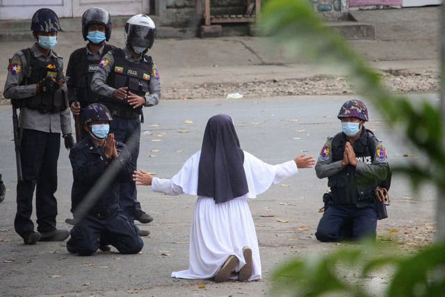 A nun is seen pleading with police not to harm protesters in Myitkyina in Myanmar’s Kachin state on Monday