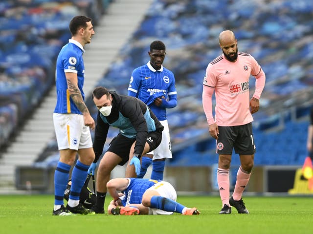 Brighton striker Neal Maupay receives treatment for a head injury
