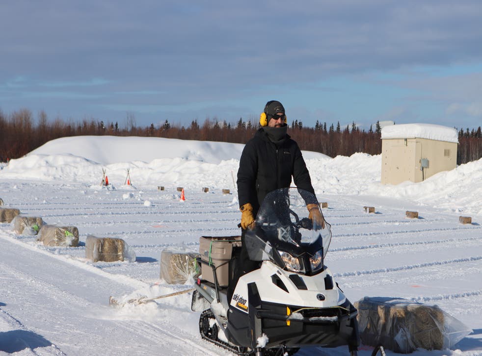 <p>A snow machiner drags a pallet to smooth out snow lanes in the new dog lot which has been set up at the McGrath checkpoint to accommodate COVID-19 precautions during the Iditarod Sled Dog Race on Tuesday March 9, 2021, in Alaska</p>