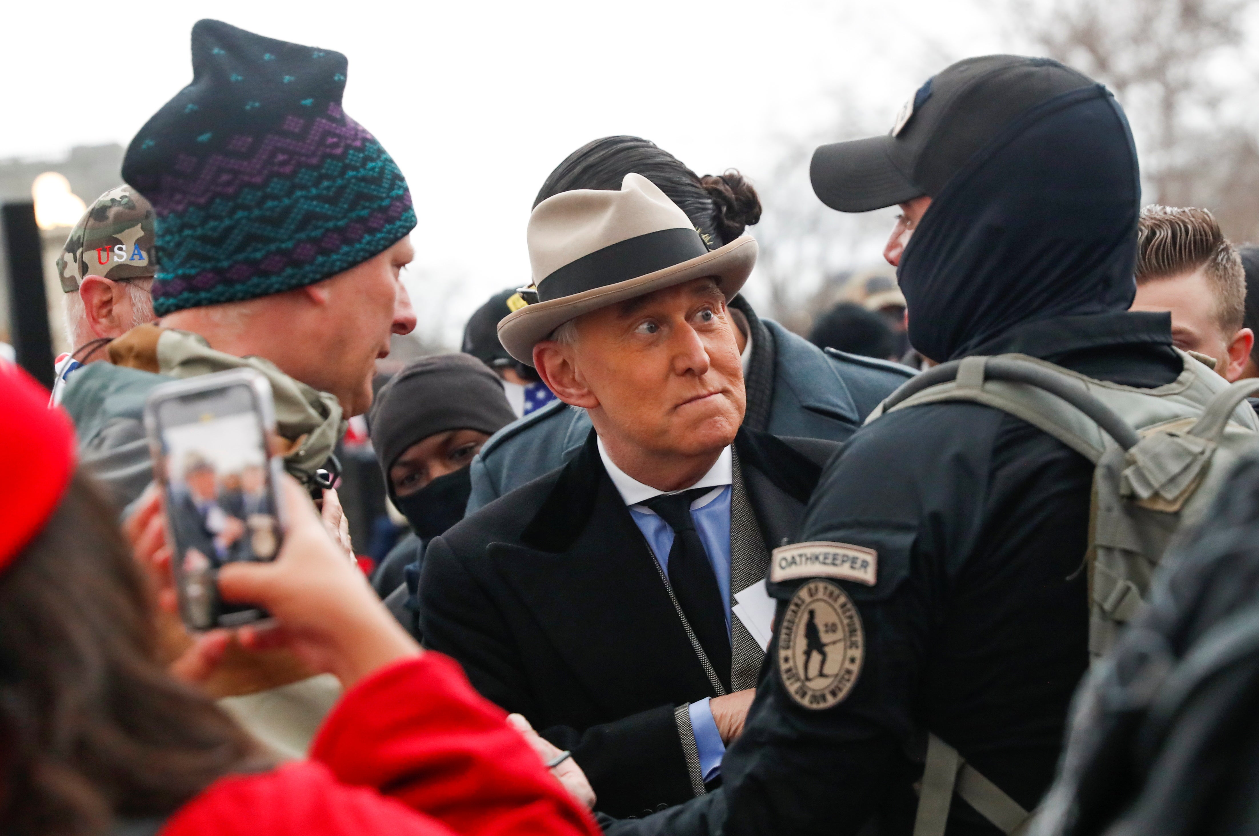 Roger Stone, center, meets with supporters of Donald Trump