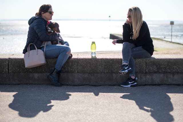 <p>Two friends from different households meet for a chat on Chalkwell beach on March 9, 2021 in Southend-on-Sea, England</p>