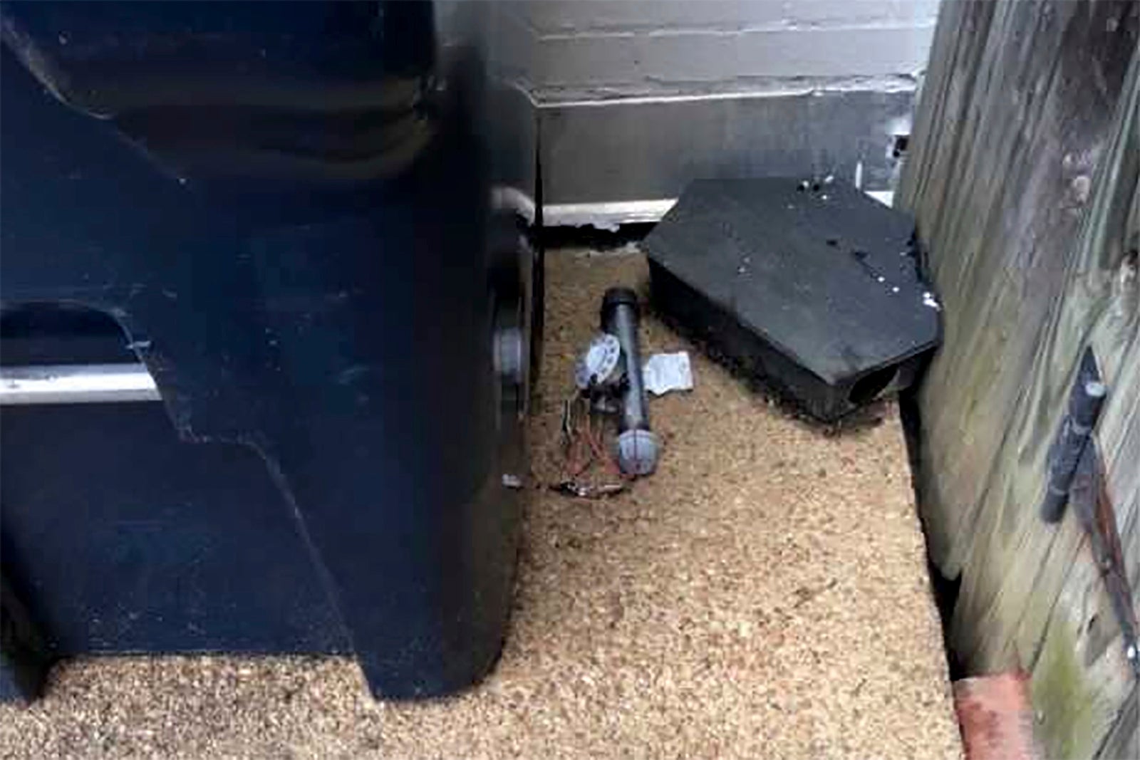 In this Jan. 6, 2021 photo, an explosive device is shown outside of the Republican National Committee office in Washington. The FBI has released new video showing someone placing two pipe bombs outside the offices of the Republican and Democratic national committees the night before the Jan. 6 riot at the U.S. Capitol.