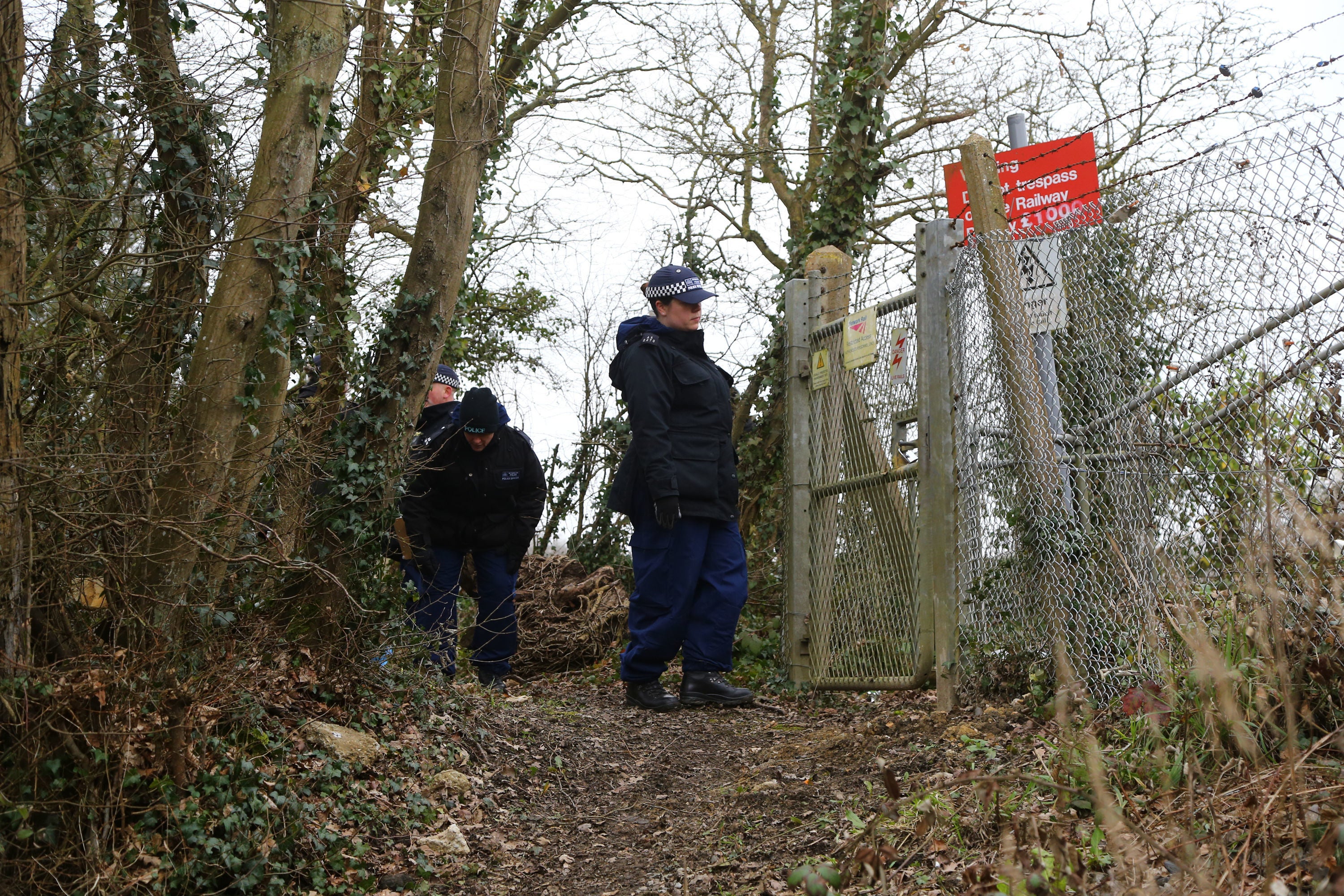 Officers from the Metropolitan Police search woodland near to Great Chart Golf and Leisure in Ashford, Kent