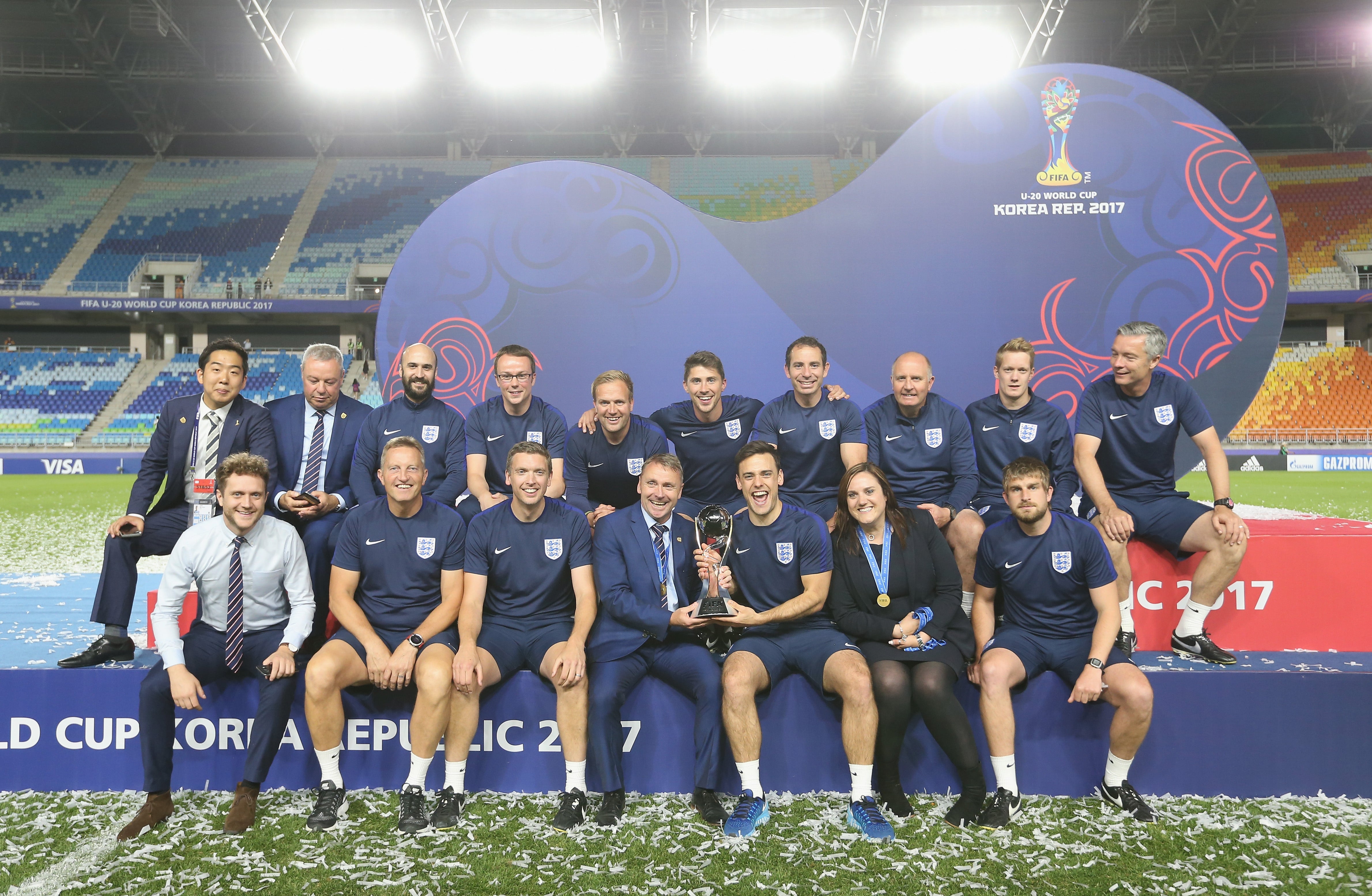 Meziane, alongside other England staff, celebrate with the U20 World Cup trophy