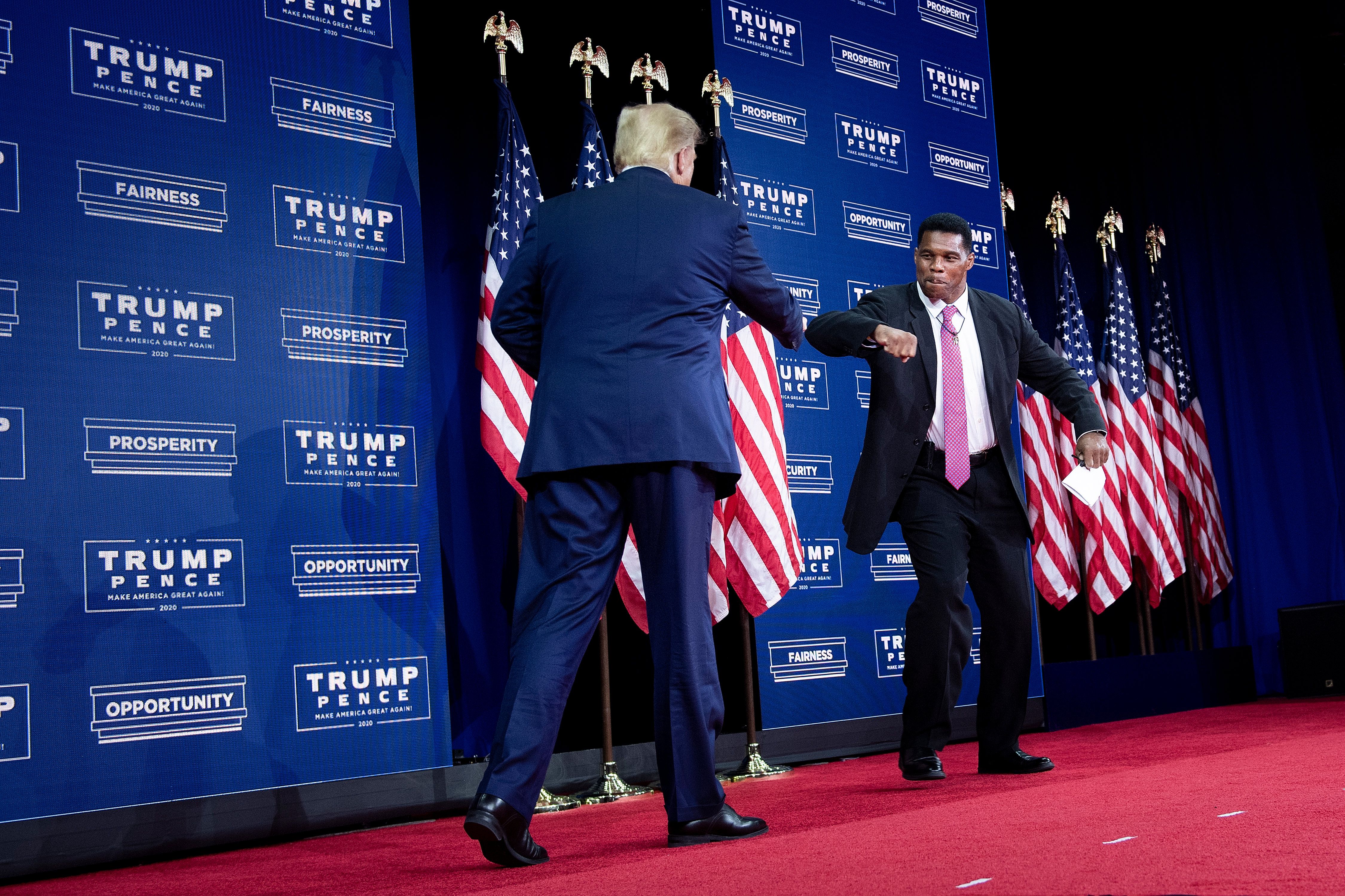 US President Donald Trump is greeted by NFL hall of fame member Herschel Walker during an event for black supporters at the Cobb Galleria Centre September 25, 2020, in Atlanta, Georgia