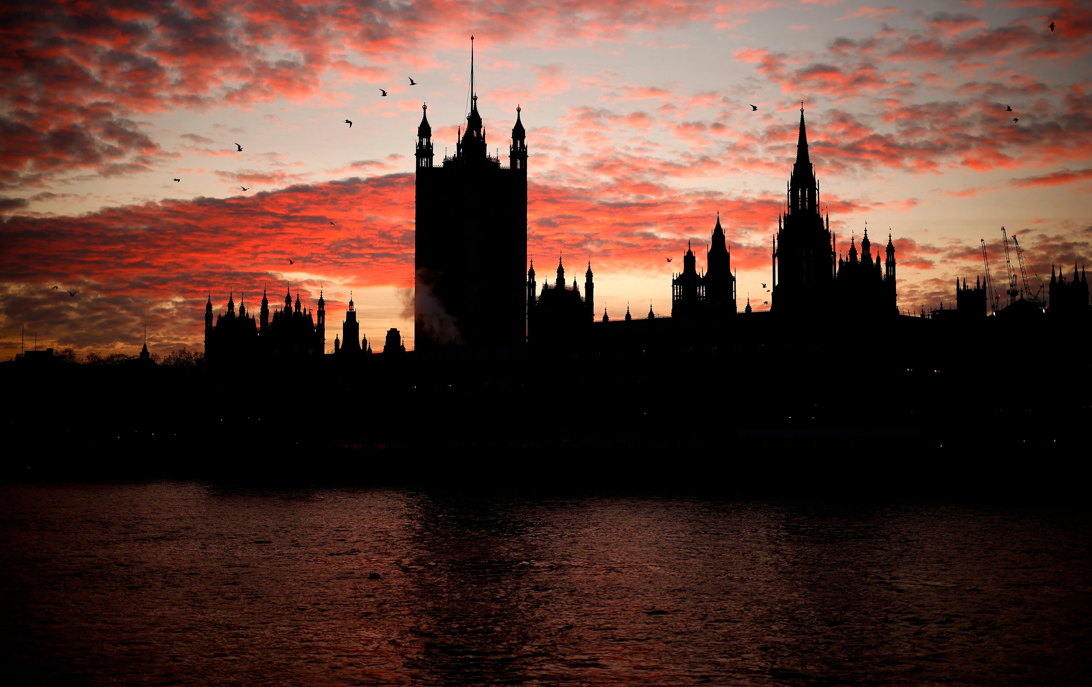The sun sets behind the Victoria Tower at the Palace of Westminster, home to the Houses of Parliament