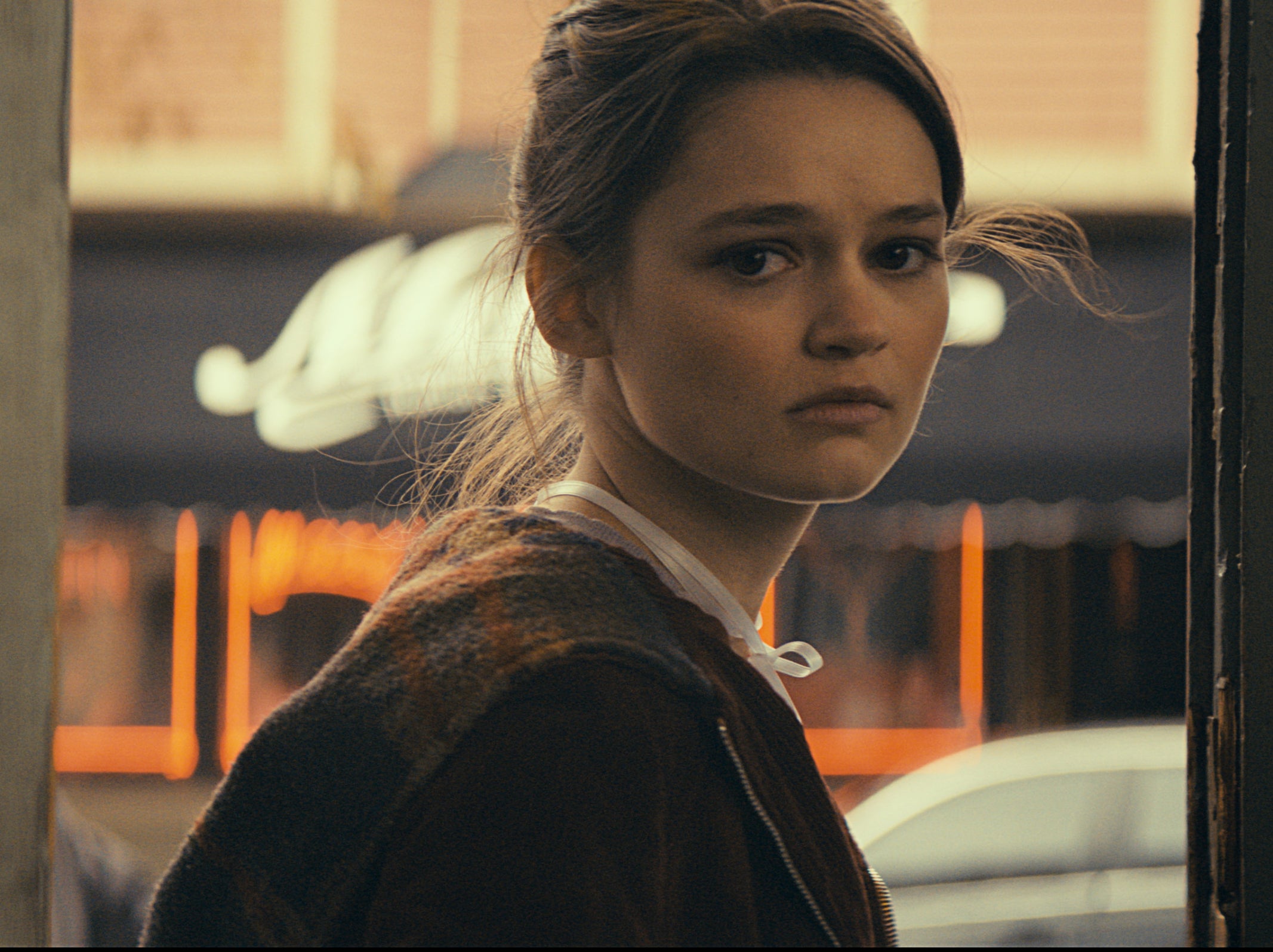 The protagonist’s wife, dream girl, and fellow addict Emily (Ciara Bravo) gets little in terms of backstory