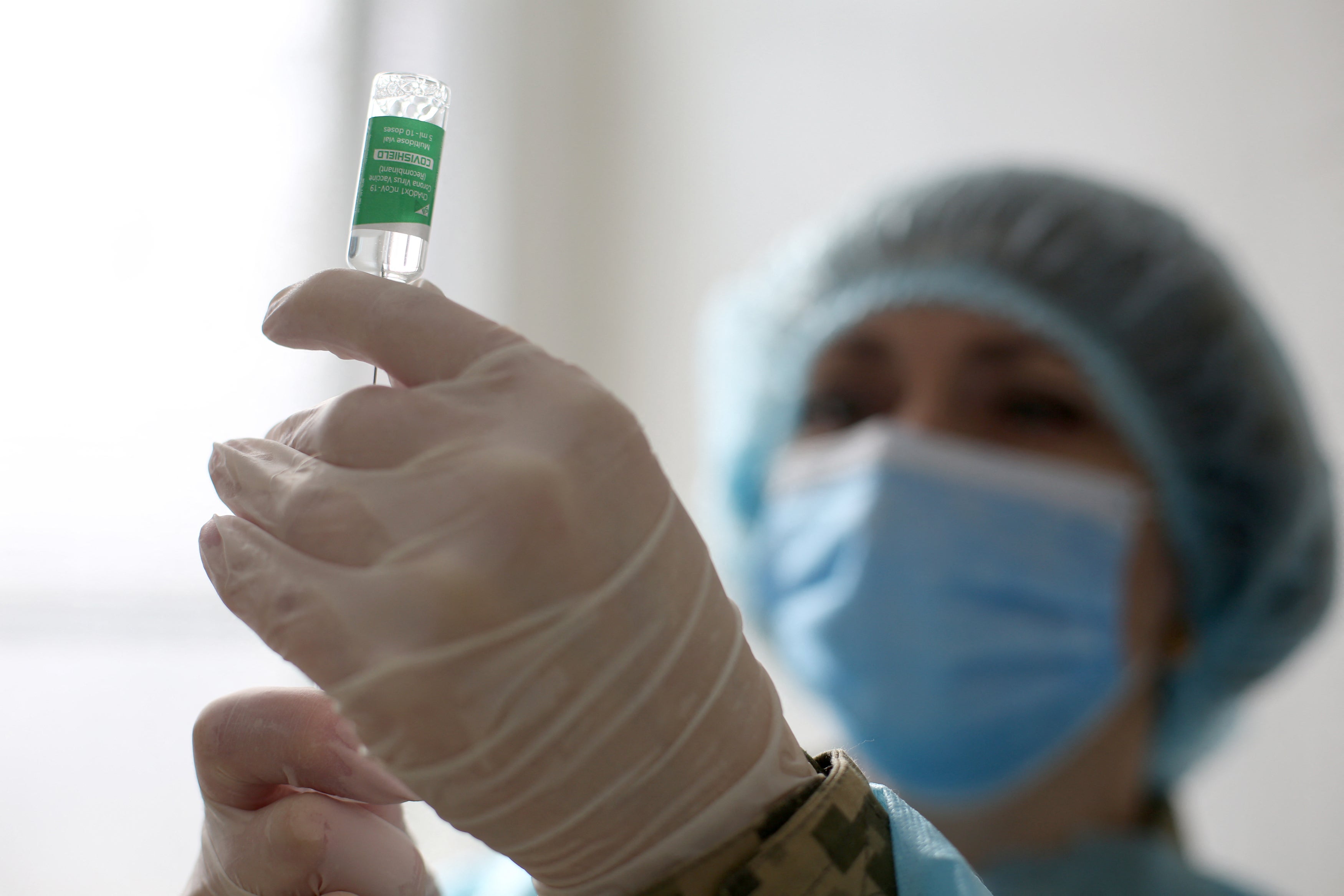 Representative: A medic preparing a dose of the Oxford/AstraZeneca vaccine against coronavirus disease