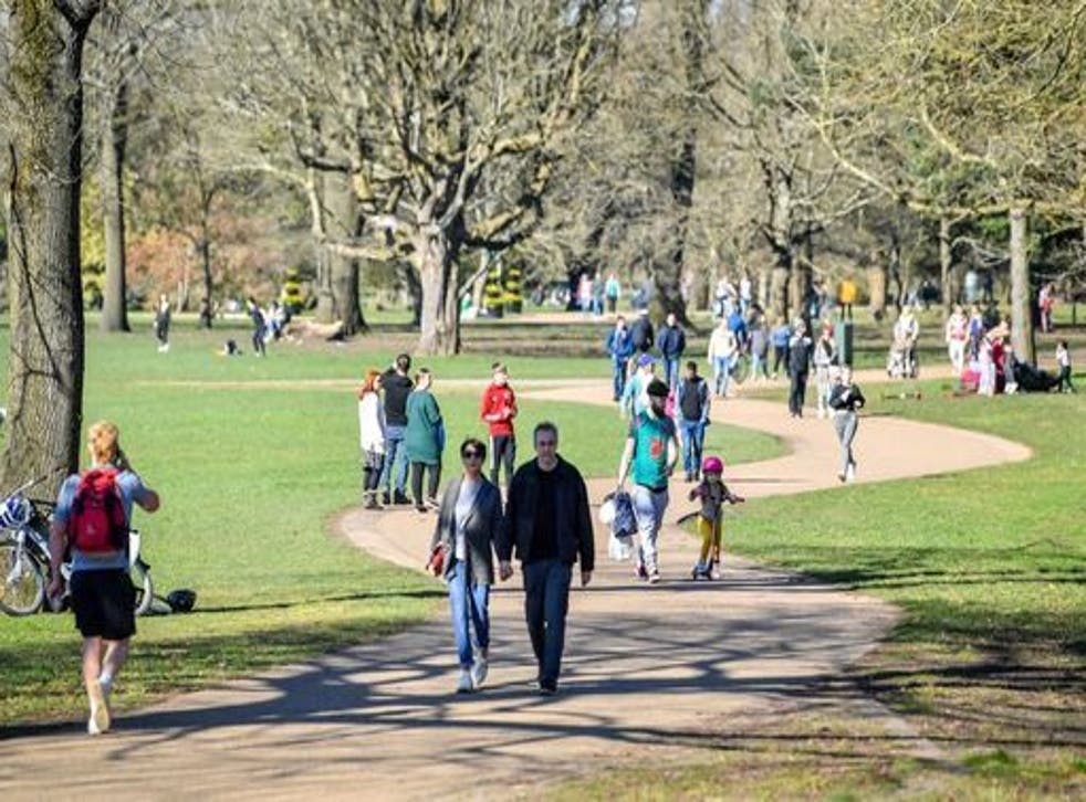 <p>Wlkers in Bute Park, Cardiff in sunny weather</p>