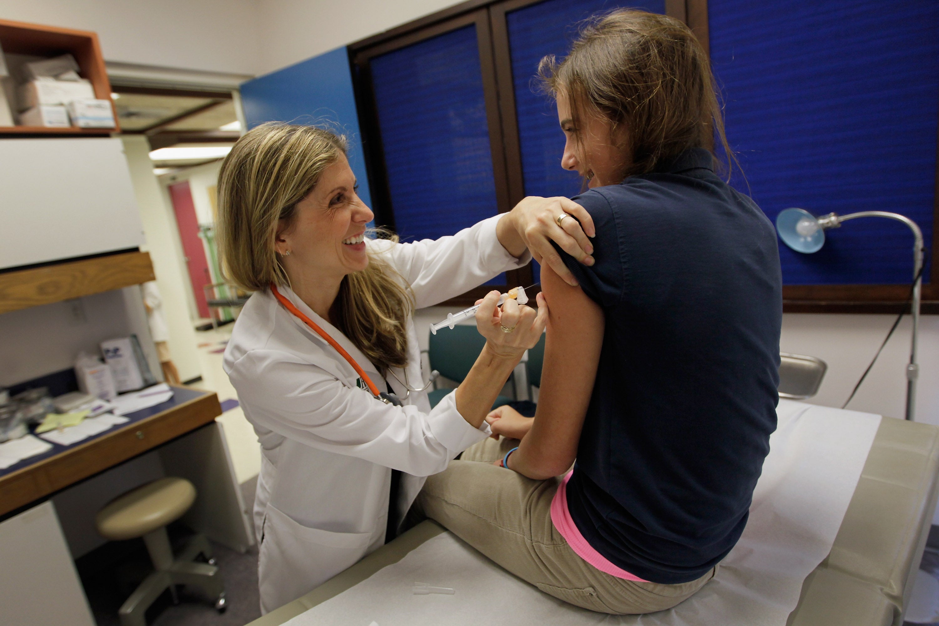 A pediatrician gives an HPV vaccination to a 13-year-old girl in Miami