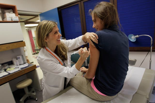 <p>A pediatrician gives an HPV vaccination to a 13-year-old girl in Miami</p>
