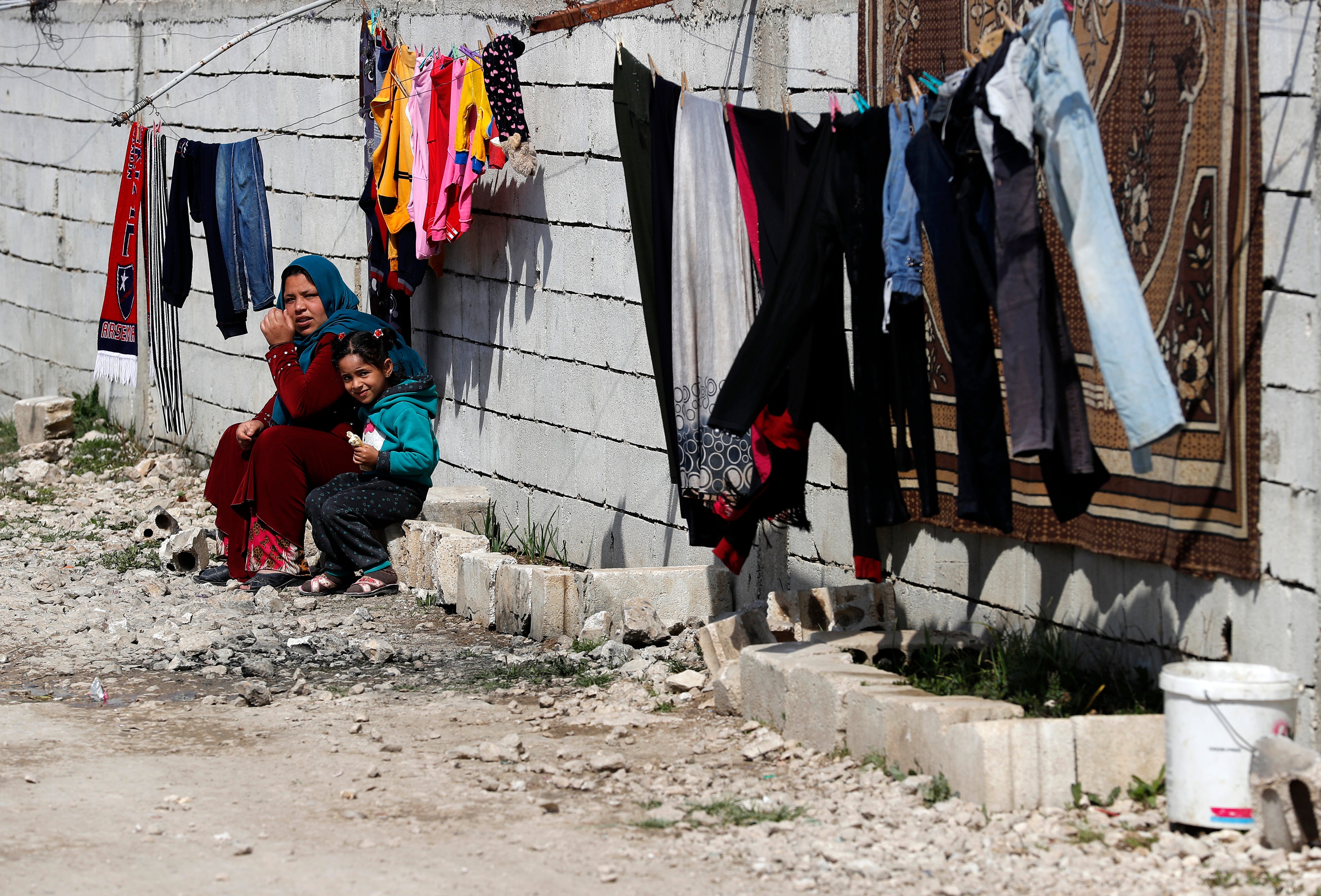 A displaced Syrian woman with her daughter at a refugee camp in Bar Elias, in eastern Lebanon's Bekaa Valley
