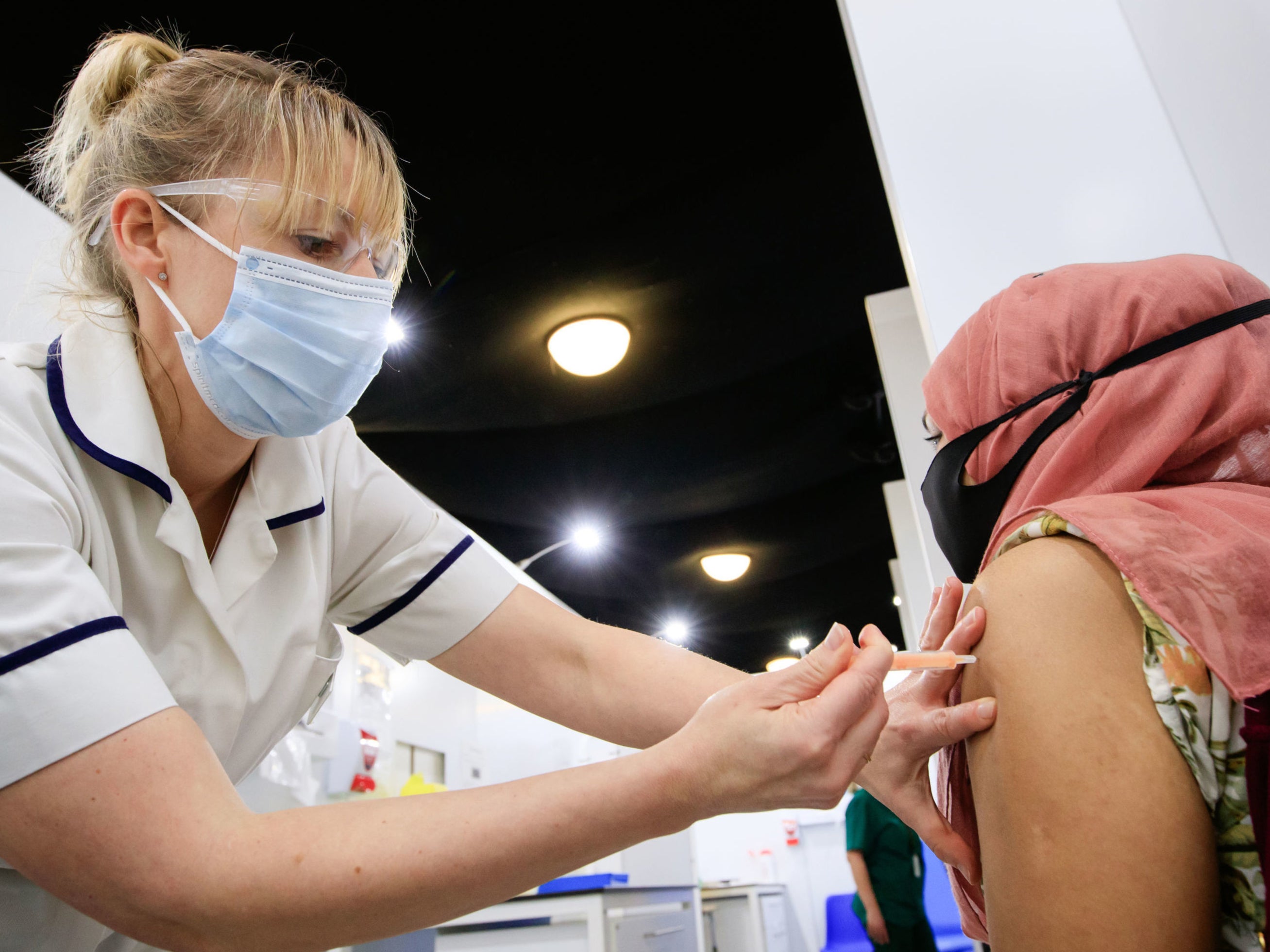 A woman receives an injection of the the Oxford/AstraZeneca coronavirus vaccine at Elland Road vaccine centre in Leeds