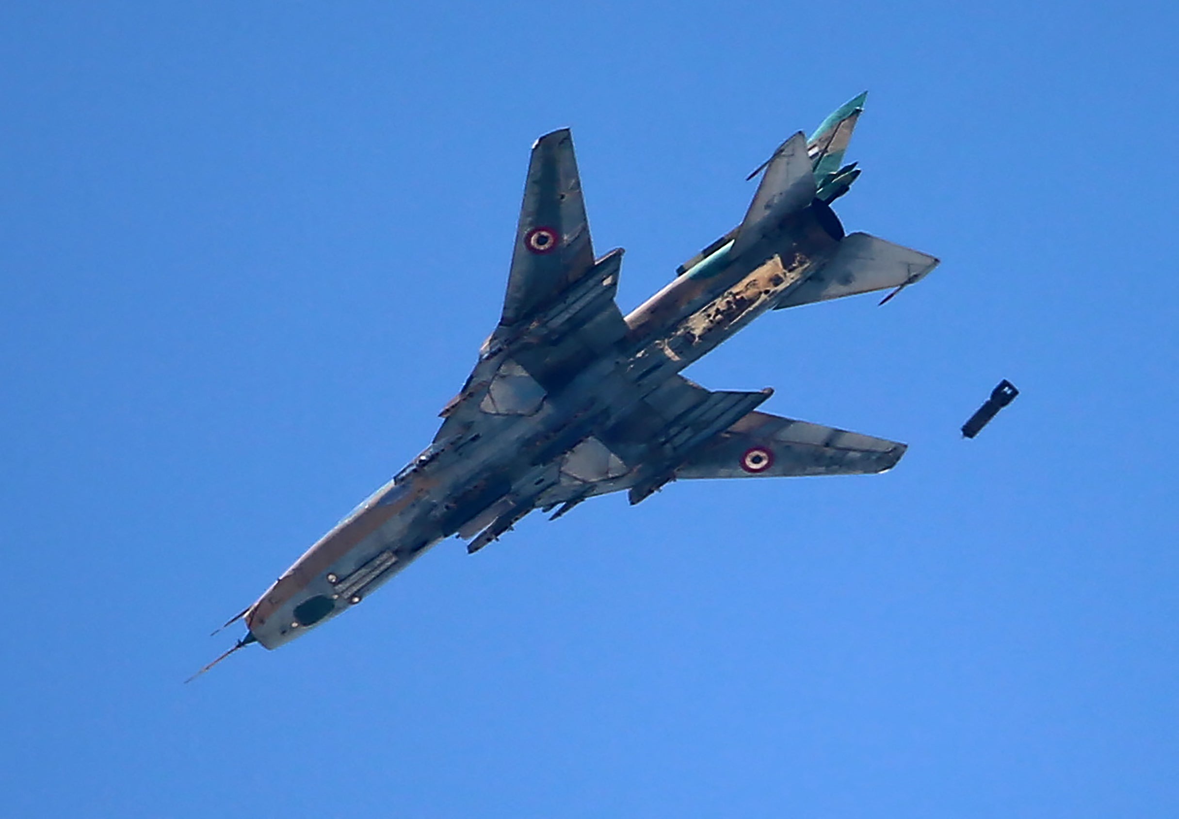 A Syrian air force Sukhoi Su-22 fighter drops a bomb on Jobar, the rebel-held area of Damascus, in June 2017