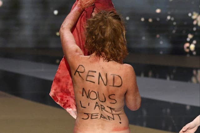 Masiero’s back reads: ‘Give us back our art, Jean,’ a direct plea to prime minister Jean Castex