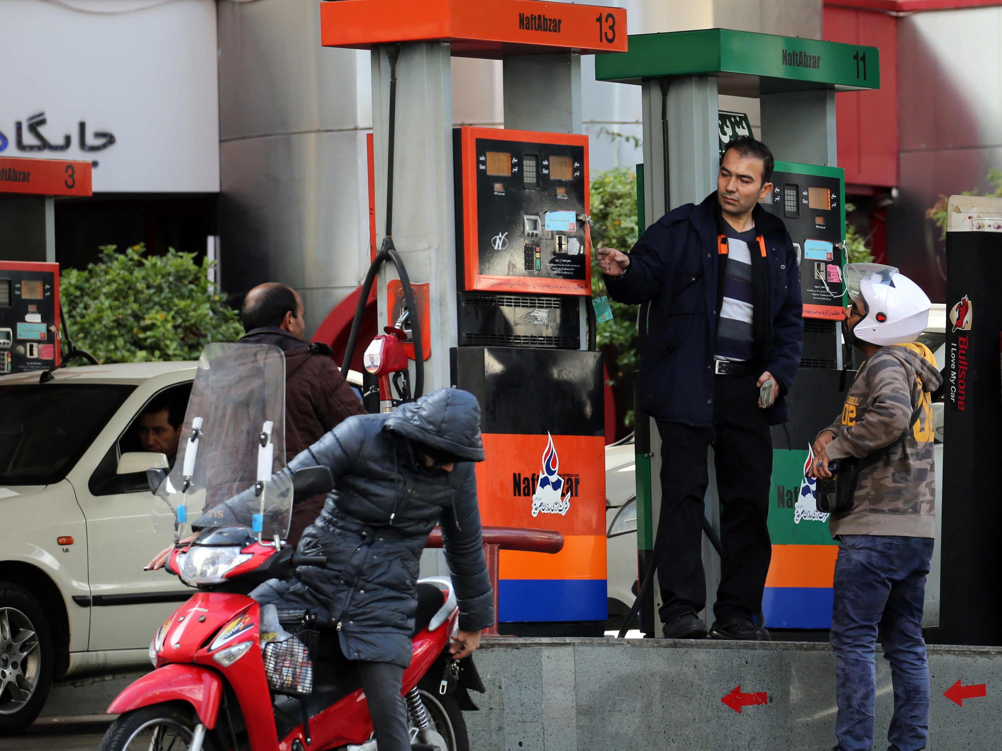 Iranians fill their vehicles at a petrol station in Tehran, in 2019, shortly after Iran imposed petrol rationing and raised pump prices by 50% to cut costly subsidies that have fuelled high consumption and rampant smuggling
