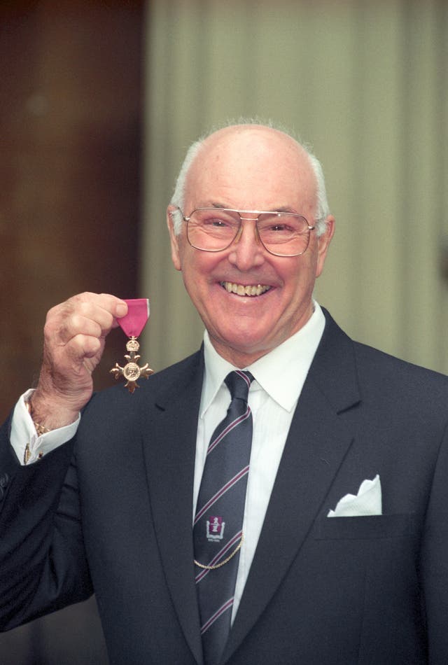 <p>Murray Walker with his OBE in 1996</p>