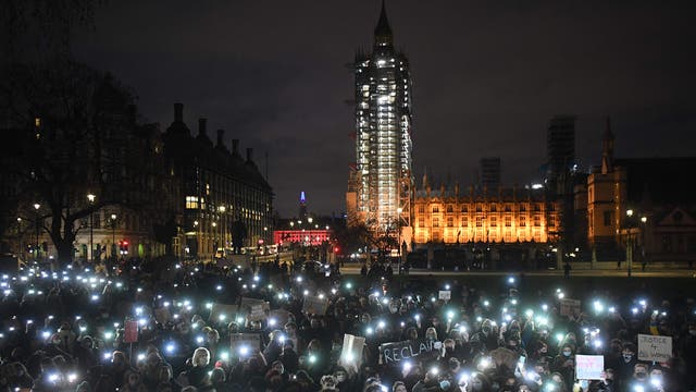 Protesters calling for greater public safety for women after the death of Sarah Everard, against the police handling of a gathering on Clapham Common in Sarah Everard's honour and against a proposed law that would give police more powers to intervene on protests hold up their mobile phones with their torches illuminated in Parliament Square in central London