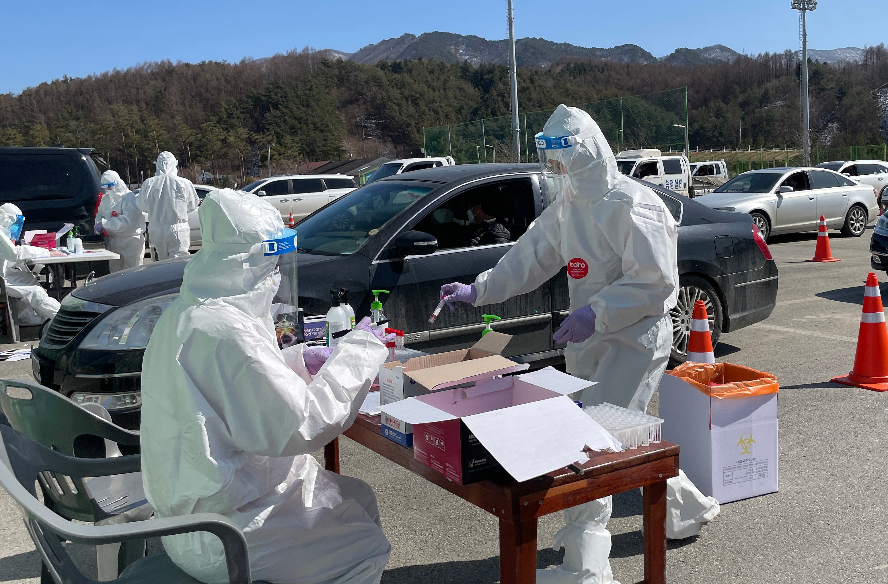 Health personnel collect swab samples at a drive-thru Covid-19 testing station in Jinbu, Pyeongchang, South Korea on 10 March 2021