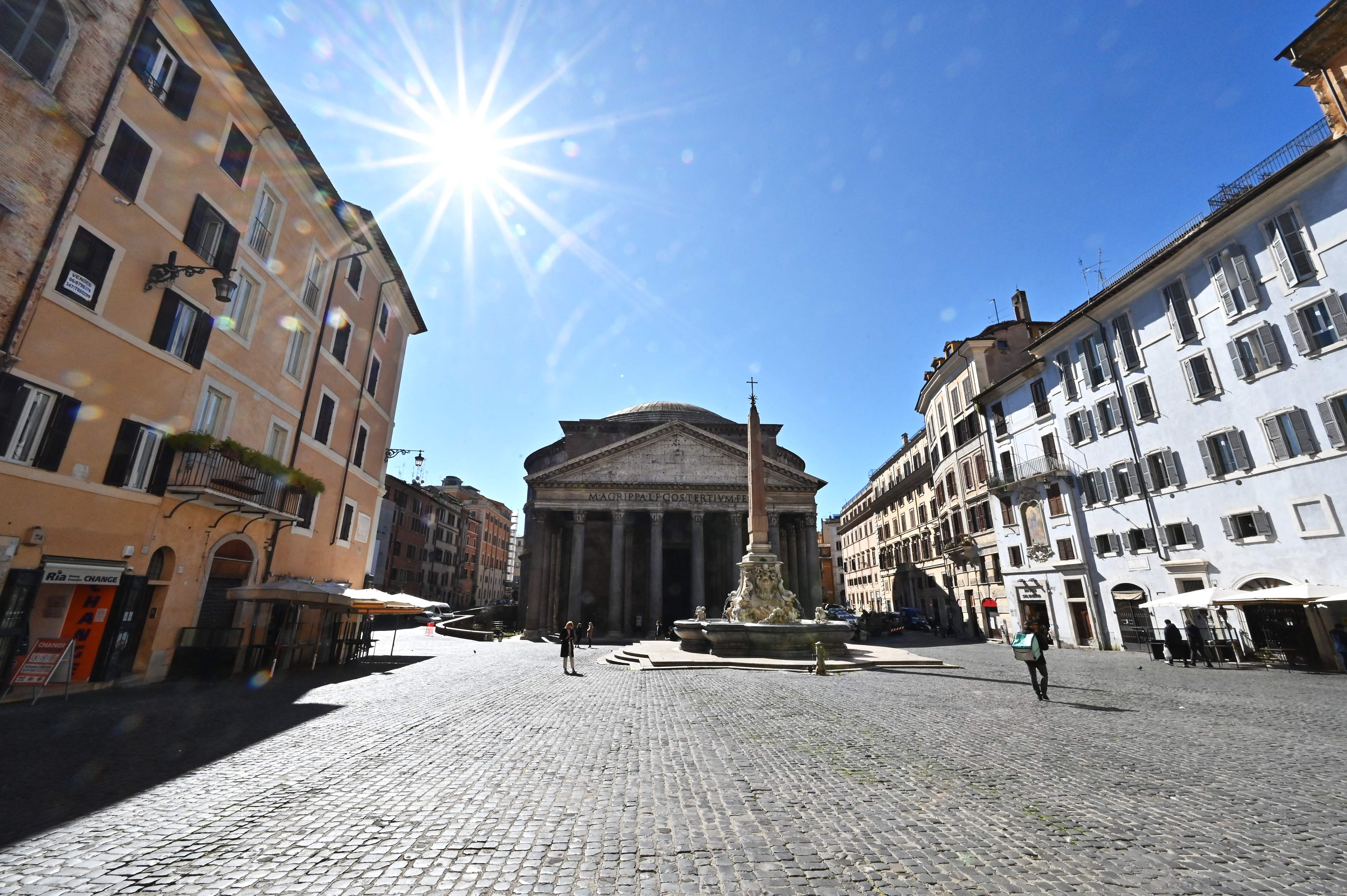 People walk on the Piazza della Rotonda square in front of the Pantheon monument in central Rome as three-quarters of Italians entered a strict lockdown