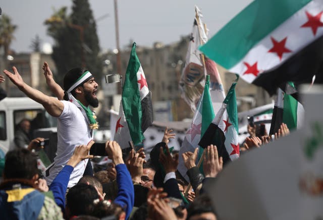 <p>Anti-Syrian government protesters in Idlib mark 10 years since the start of a popular uprising against Assad</p>