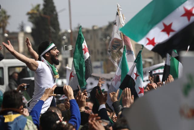 <p>Anti-Syrian government protesters in Idlib mark 10 years since the start of a popular uprising against Assad</p>